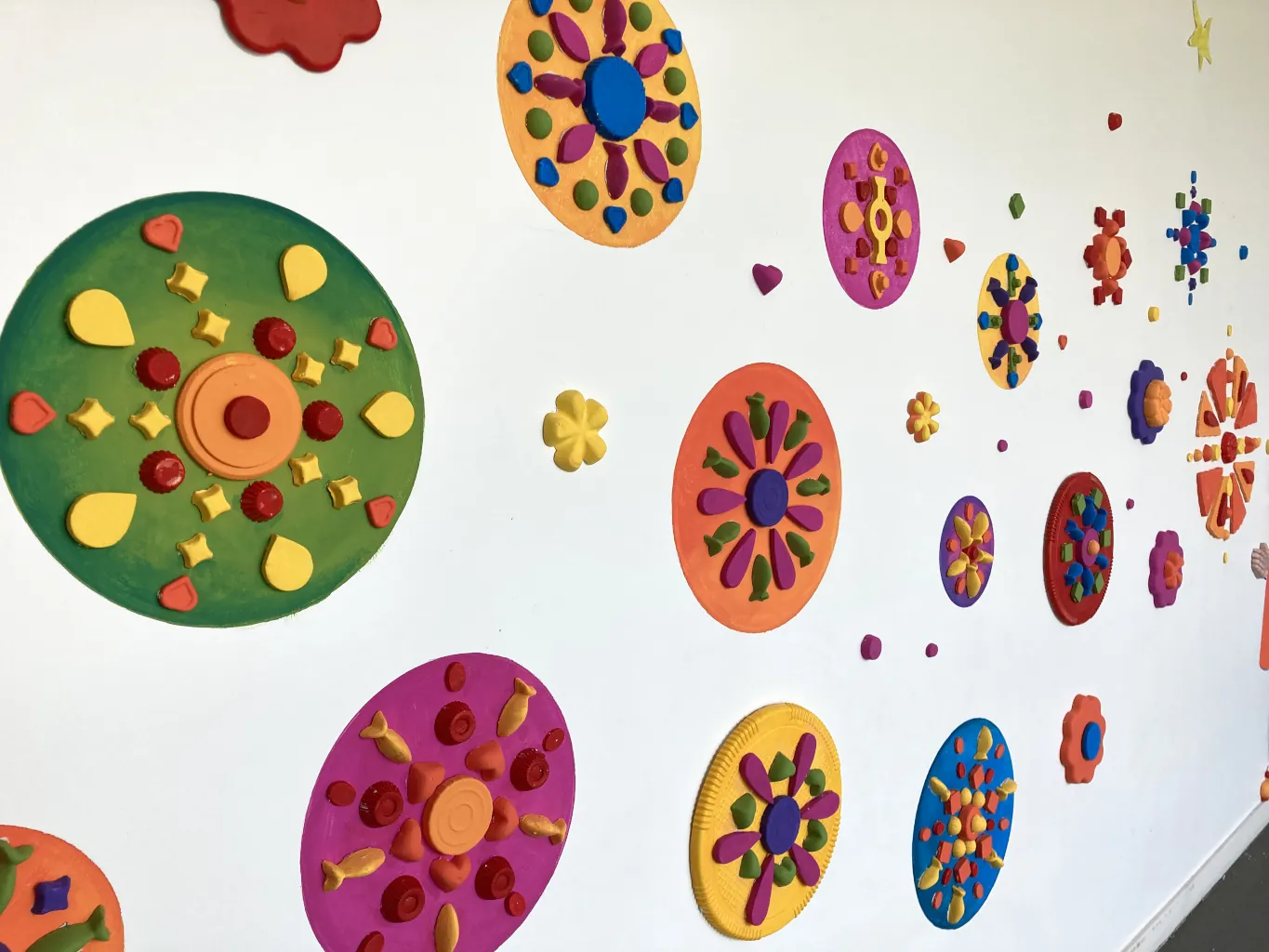 La fresque kit réalisée en Juin 2023 par les élèves de maternelle avec des emballages plastique - Atelier participatif de Karine Bracq, artiste plasticienne